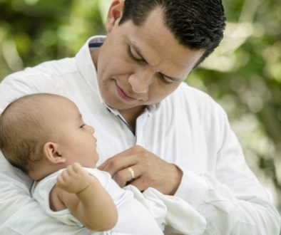 a father holding his child representing the benefit of Term life insurance for families