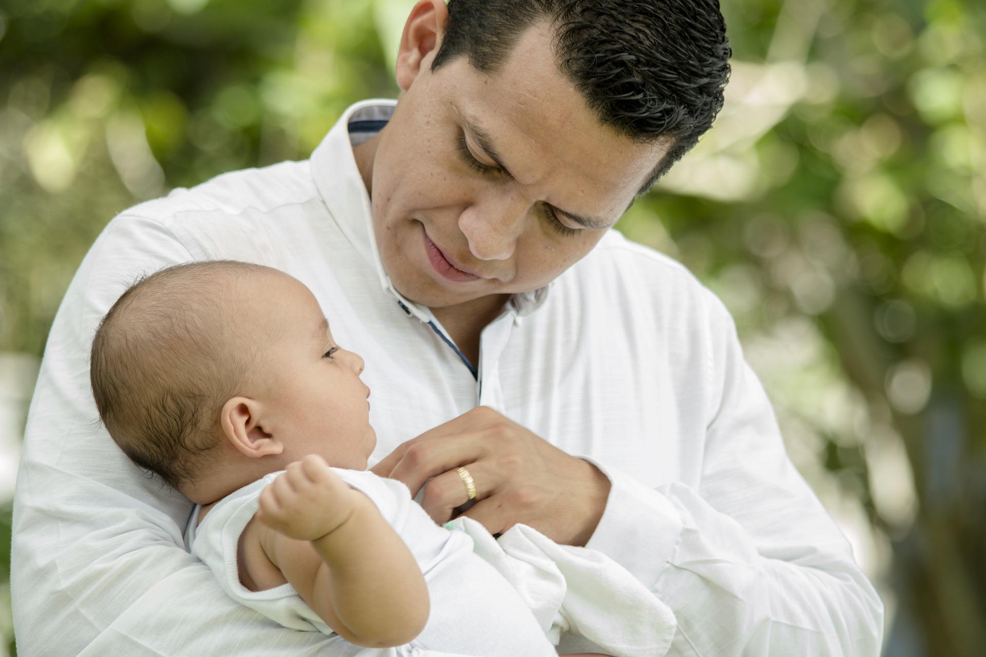 a father holding his child representing the benefit of Term life insurance for families